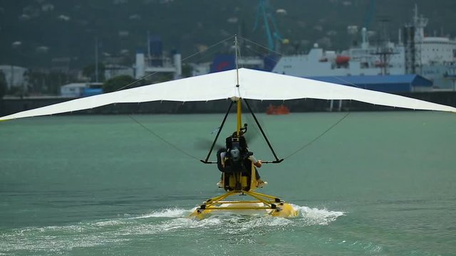 Water hang-glider taking off, active vacation, extreme sports in Batumi Georgia
