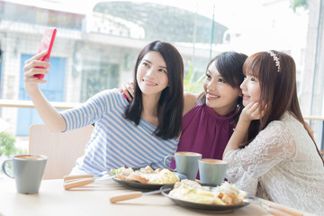 happy woman friends in restaurant