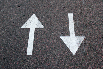 Two arrows on asphalt. Sign of two-way street.