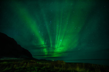 Northern lights and silhouettes of mountains.  night photo. Silhouettes of mountains. Iceland.
