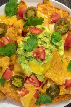 Closeup of nachos with cheese and hot peppers, Mexican snack