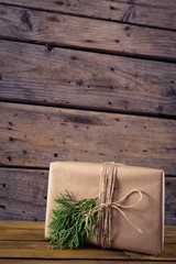Gift box, fir and pine cone on wooden table