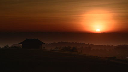 Fototapeta na wymiar Silhouette small home while sunrise