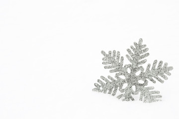 Silver snowflake in the white snow. Mock up for holiday post card and Christmas offers as advertising or other ideas. Winter time concept. Empty place for a text.