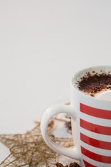 Coffee with cinnamon powder and christmas decorations