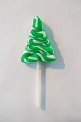 Christmas tree lollipop on white background