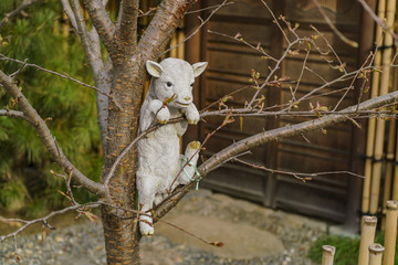 Cut sheep statue hanging on the tree