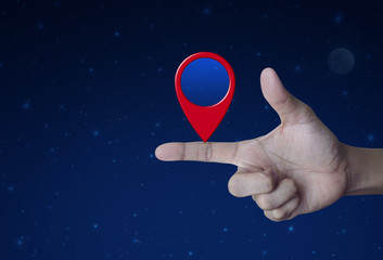 Map pin location button on finger over fantasy night sky and moon, Map pointer navigation concept