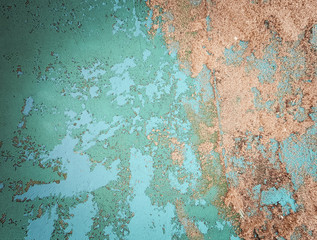 blue faded surface with peeling paint and sand