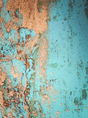 blue faded surface with peeling paint and sand