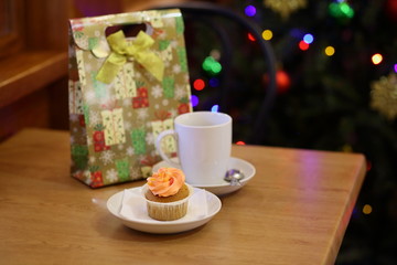 coffee Cup and cake on the table near the Christmas tree