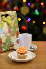 coffee Cup and cake on the table near the Christmas tree