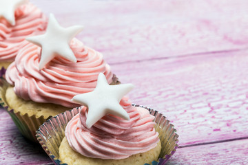 Christmas cupcakes with a star on the wooden table