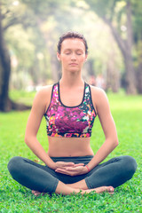 Active woman in yoga position joined hands for meditation