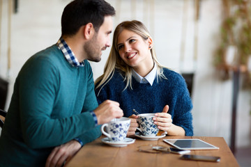 Young beautiful couple having date in coffee shop