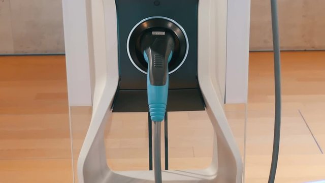 View on the column for refueling electric vehicles and cable. Ecologically clean transport. Portable refueling for electric vehicles