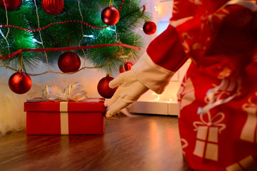 Santa delivering presents under Christmas tree