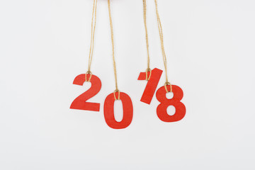 Obraz na płótnie Canvas close up view of 2018 year sign hanging on strings isolated on white