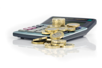 Pound Coins with Calculator on White Reflective Background