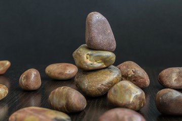 Vertical balance natural stones pebbles on the table