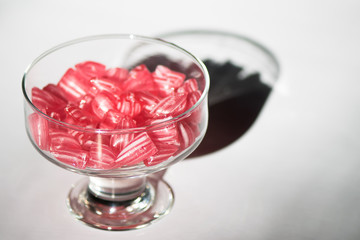 Candy canes in a glass cup.