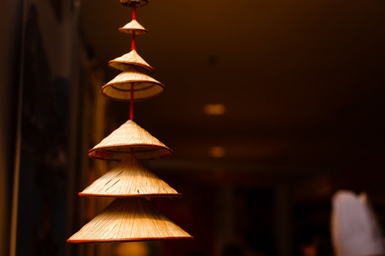 Vietnamese Traditional Conical Hats Hanging On Wire For Decoration.