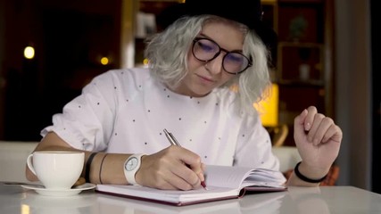 Businesswoman writing in the daily planner