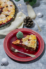 Apple cranberry pie. White and red background. Christmas decoration.