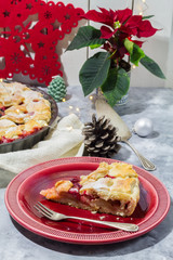 Apple cranberry pie. White and red background. Christmas decoration.