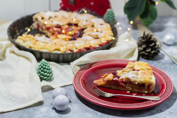 Apple cranberry pie. White and red background. Christmas decoration.