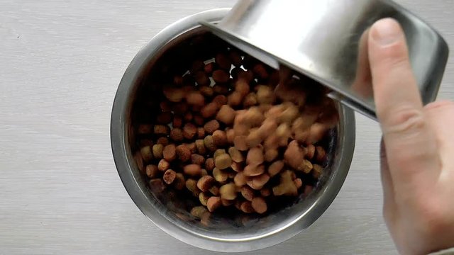 The video shows dog food is poured into a bowl