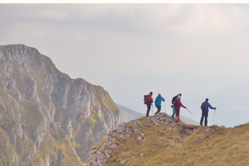 Obraz premium Group of People of different age and ethnicity walking up on Mountain Trail during Hike