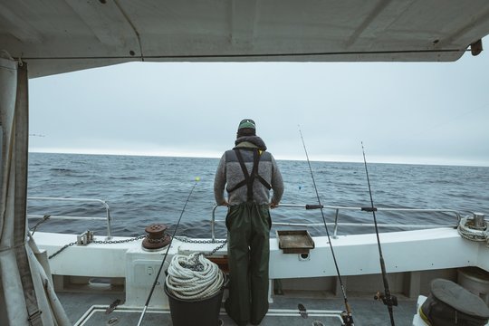 Fisherman standing on boat