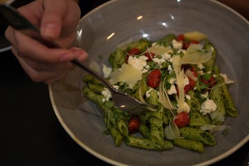 Person having pasta in restaurant