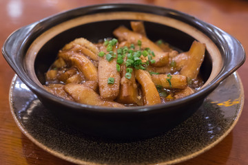 Chinese traditional dish in a black plate
