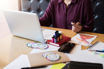 Young woman dressmaker or designer working as fashion designers and drawing sketches for clothes and choose color bar in tablet, profession and job occupation, Fashion Designer Stylish Concept