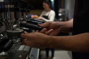 Mid section of waiter working at counter