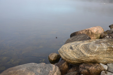 early morning fog along shores of Bobcageon Ontario