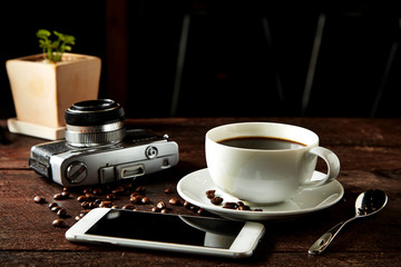 coffee camera and smartphone on wooden table