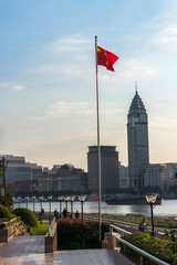 Huangpu river sunset view with Chinese flag in Shanghai, China