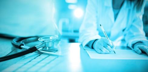 Composite image of close-up of keyboard with stethoscope