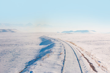 Deep Winter Train Tracks and Mountains