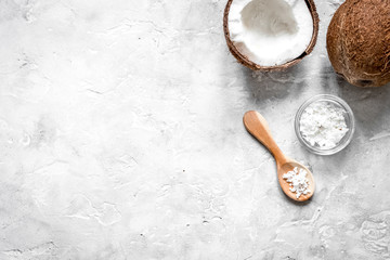 fresh coconut with cosmetic oil in jar on gray background top vi