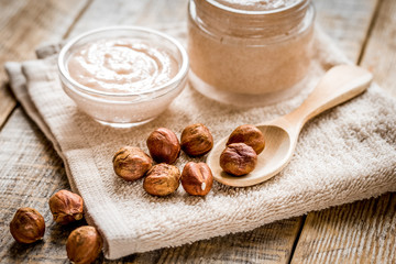 spa concept with hazel-nuts and scrub on wooden background