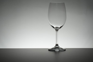 Crystal glass illuminated on mirror and black background