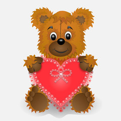 Toy bear holding in the paws of a heart postcard