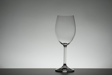 Crystal glass illuminated on mirror and black background