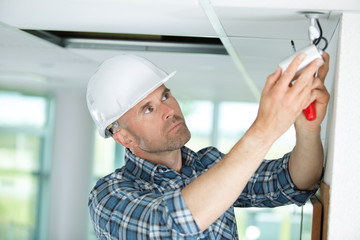 technician worker adjusting video surveillance system