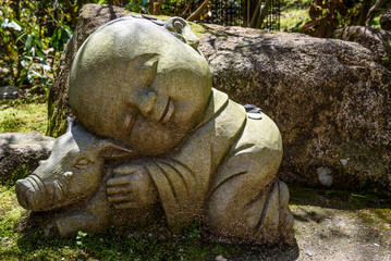 Fototapeta na wymiar Stone buddha in garden
