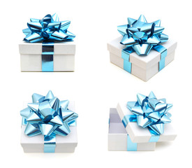 White gift boxes with a blue bow on white background